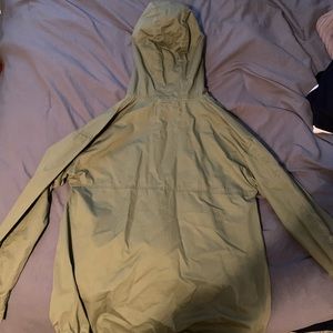 A green sweatshirt/ sweater.